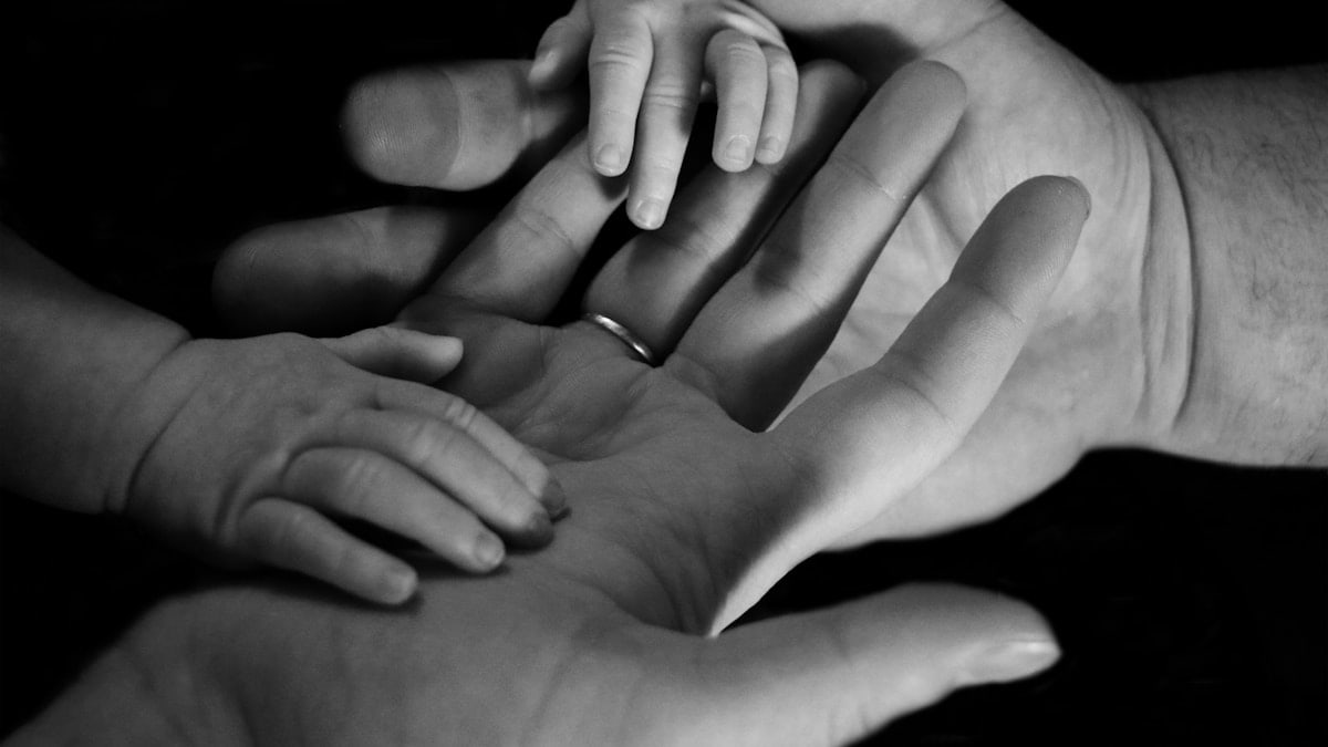 babys hand on human palm
